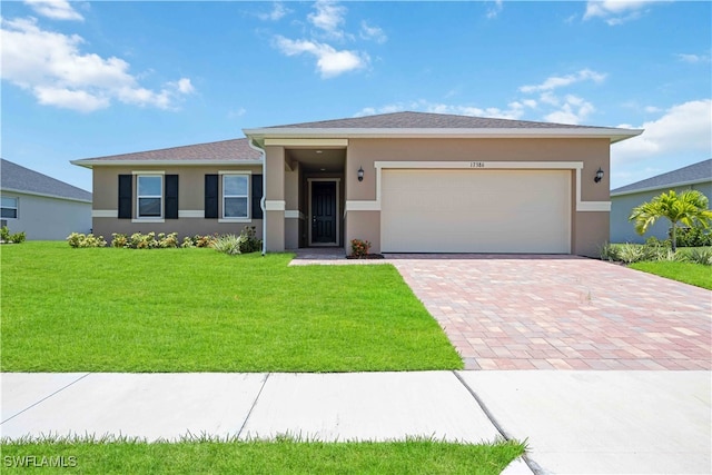 prairie-style house featuring a garage and a front lawn