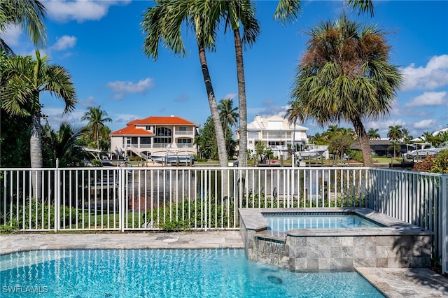 view of swimming pool featuring an in ground hot tub