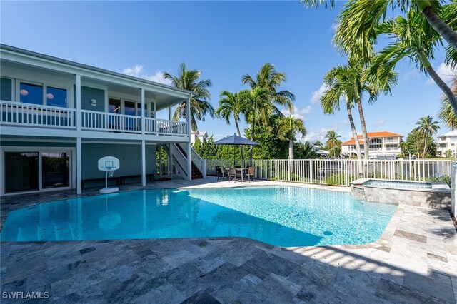 view of pool with an in ground hot tub and a patio area