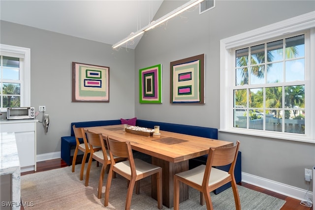 dining room with lofted ceiling and hardwood / wood-style floors