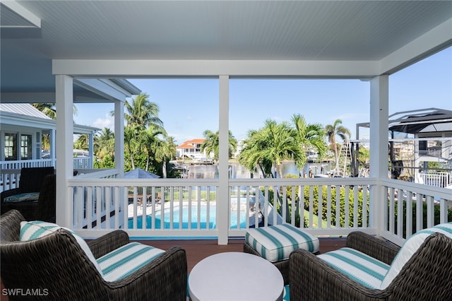 sunroom / solarium with a water view