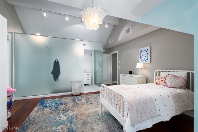 bedroom with an inviting chandelier, dark hardwood / wood-style floors, and vaulted ceiling