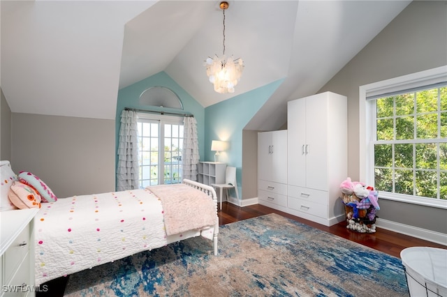 bedroom with a notable chandelier, lofted ceiling, and dark hardwood / wood-style floors