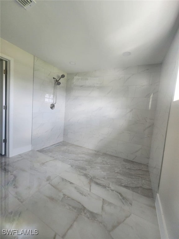 bathroom with a tile shower