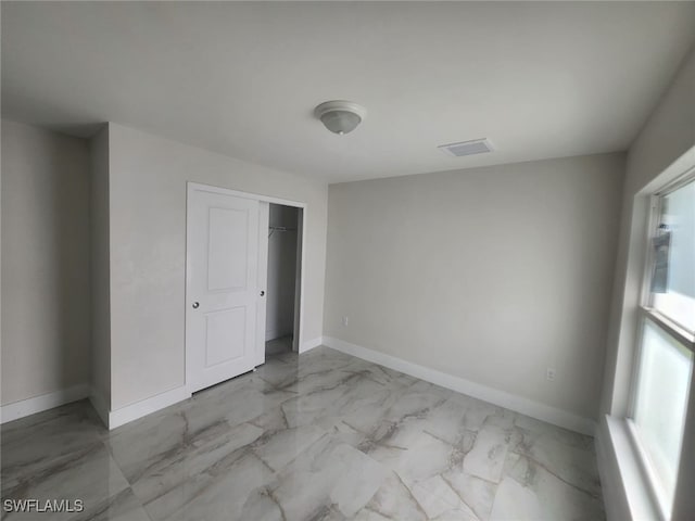 unfurnished bedroom with a closet