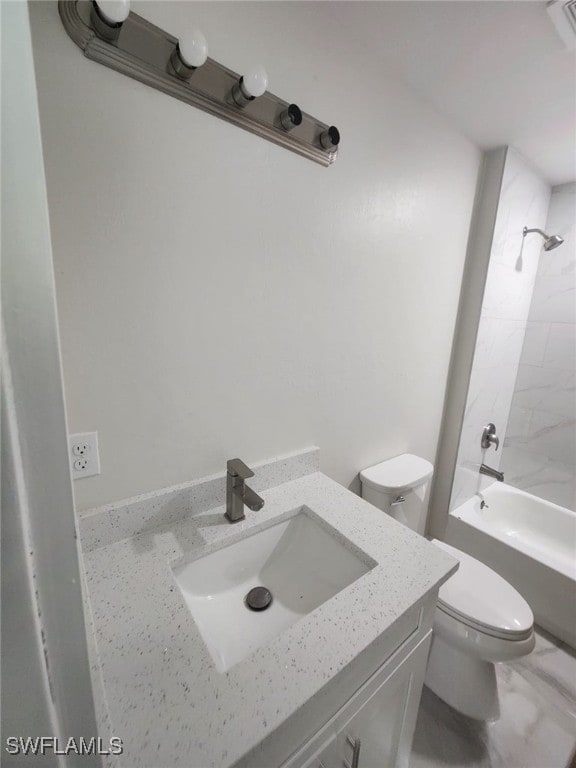 full bathroom featuring toilet, tiled shower / bath, and vanity