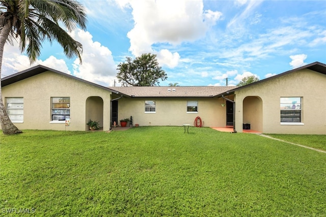 rear view of property with a yard