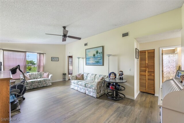 living room with a textured ceiling and hardwood / wood-style flooring