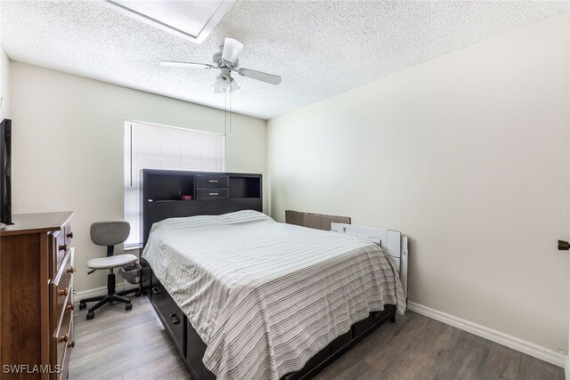 bedroom featuring a textured ceiling, ceiling fan, and hardwood / wood-style flooring