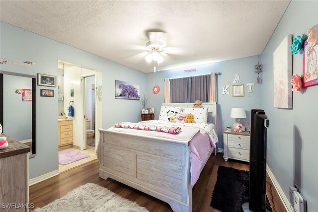 bedroom featuring a textured ceiling, ceiling fan, dark wood-type flooring, and ensuite bath