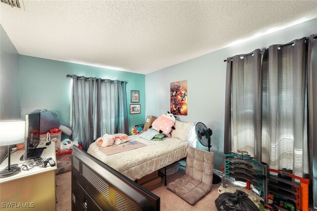 carpeted bedroom featuring a textured ceiling