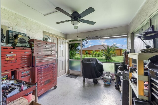 sunroom featuring ceiling fan