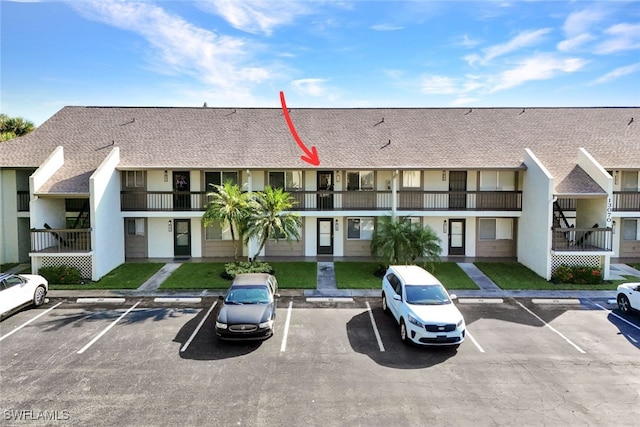 view of building exterior with uncovered parking