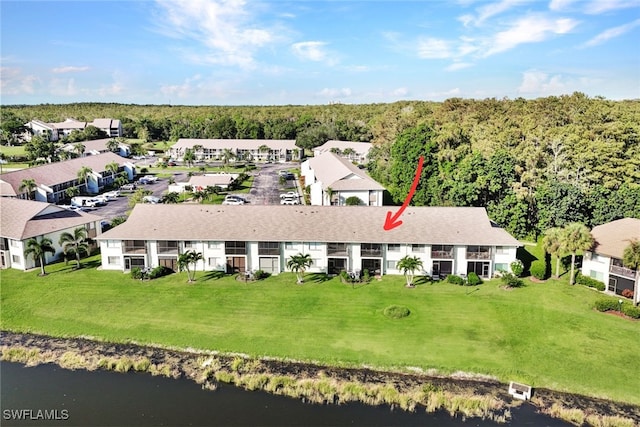 birds eye view of property with a water view and a residential view