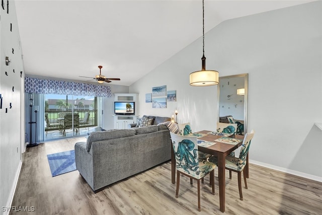 dining area with ceiling fan, high vaulted ceiling, and hardwood / wood-style floors