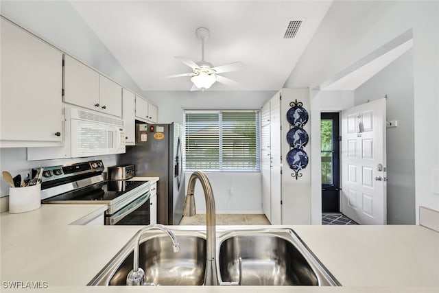 kitchen featuring sink, vaulted ceiling, stainless steel electric range, and white cabinets