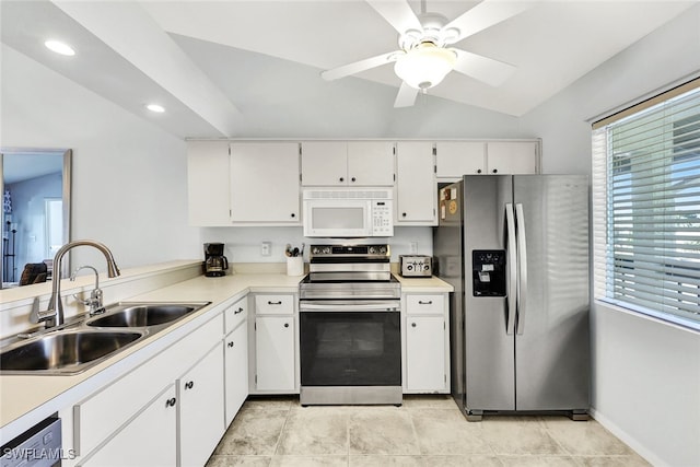 kitchen with light countertops, appliances with stainless steel finishes, white cabinetry, and a sink