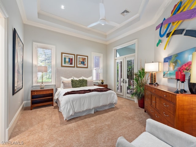 carpeted bedroom with ceiling fan, a raised ceiling, crown molding, and access to exterior