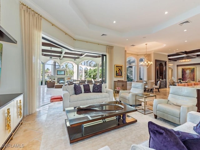 15183 Brolio Way, Naples, FL 34110 - living room featuring a raised ceiling, recessed lighting, a chandelier, and crown molding