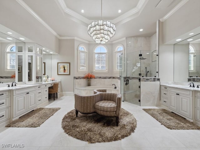 15183 Brolio Way, Naples, FL 34110 - bathroom featuring a shower stall, a garden tub, two vanities, a tray ceiling, and crown molding