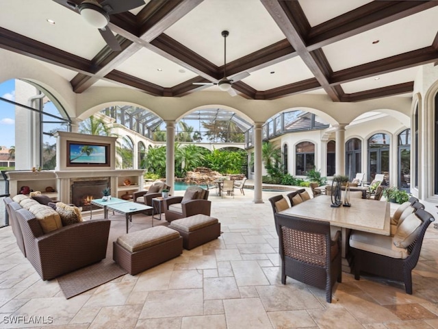 15183 Brolio Way, Naples, FL 34110 - view of patio featuring ceiling fan, outdoor dining area, and an outdoor living space with a fireplace