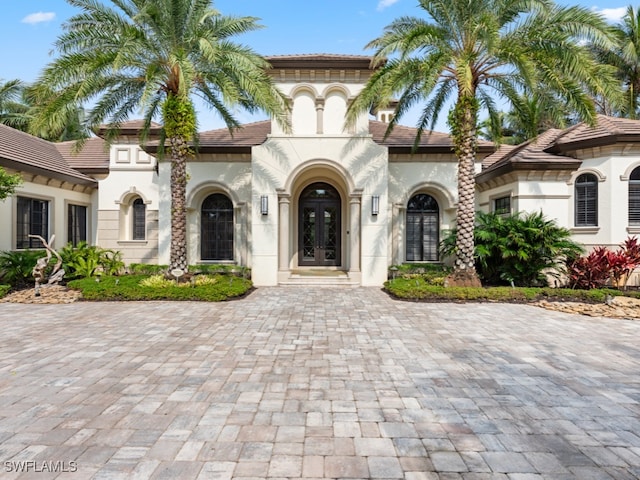 mediterranean / spanish-style house with french doors