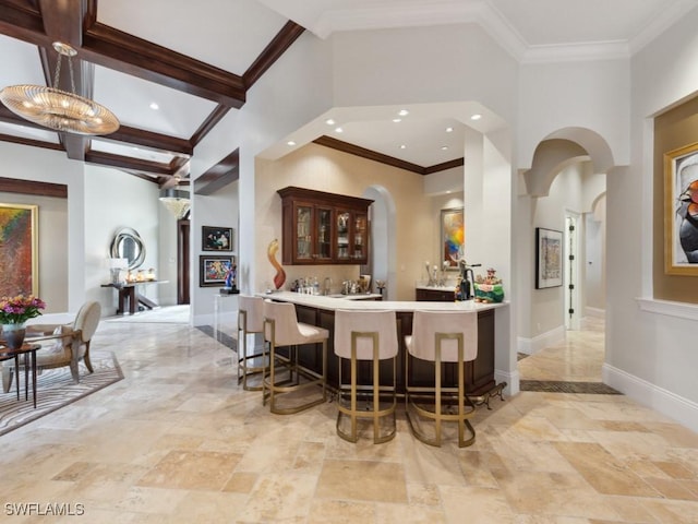 15183 Brolio Way, Naples, FL 34110 - indoor wet bar with ornamental molding, recessed lighting, arched walkways, and a high ceiling