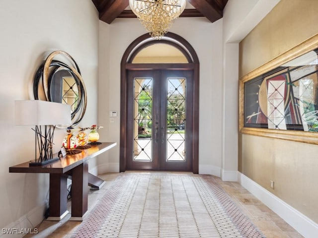 15183 Brolio Way, Naples, FL 34110 - foyer featuring french doors, a chandelier, and beamed ceiling