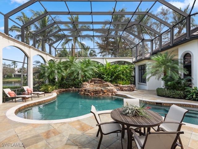 view of pool with a patio area and a lanai