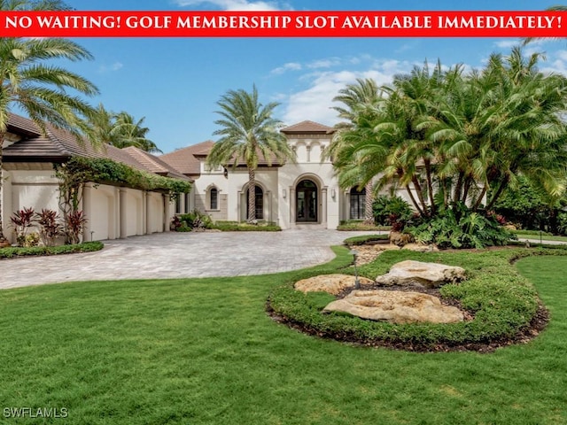 15183 Brolio Way, Naples, FL 34110 - view of grassy yard with a garage and decorative driveway