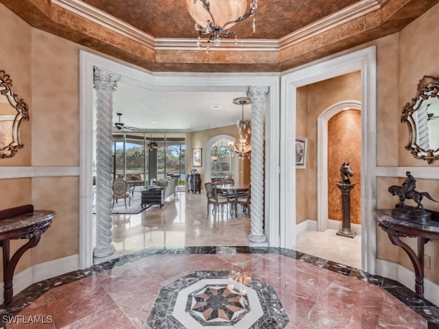 foyer entrance featuring crown molding and an inviting chandelier