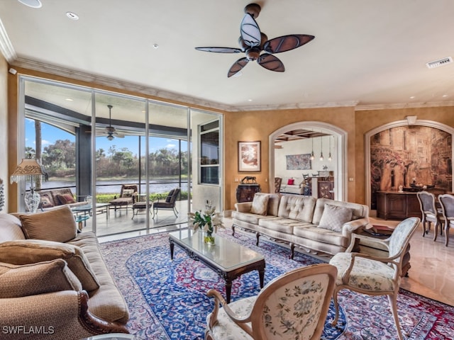 living room with a water view, ceiling fan, and ornamental molding