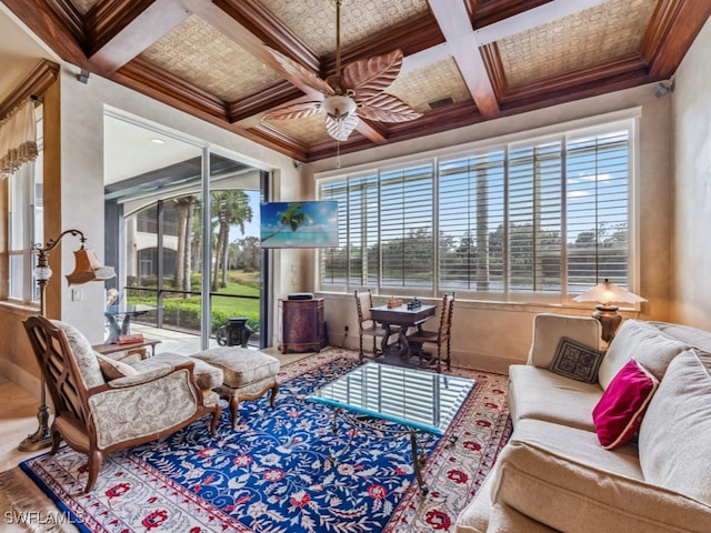 sunroom featuring a healthy amount of sunlight, ceiling fan, coffered ceiling, and beamed ceiling