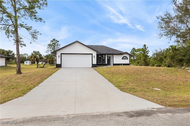 view of front facade with a front yard and a garage