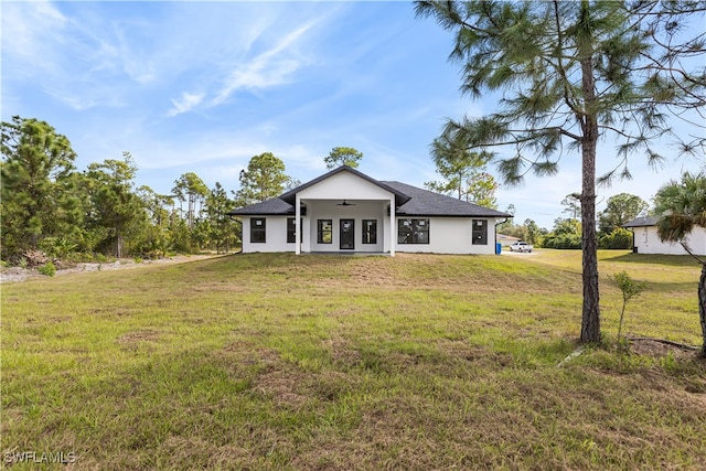 rear view of property featuring a yard