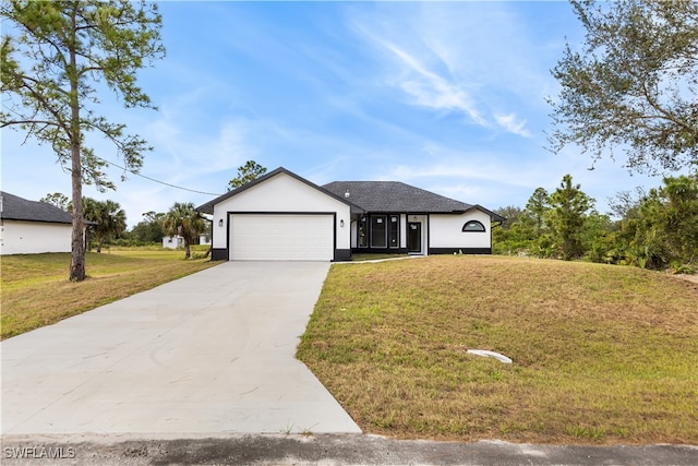 view of front of property with a garage and a front lawn