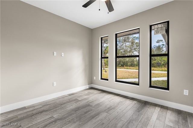 spare room with light wood-type flooring and ceiling fan