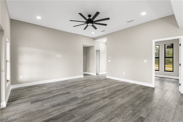 empty room with dark hardwood / wood-style floors and ceiling fan