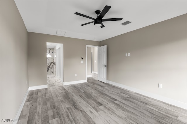 spare room with light wood-type flooring and ceiling fan