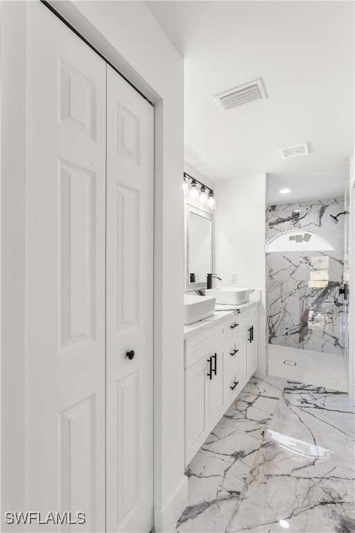 bathroom featuring a shower and vanity