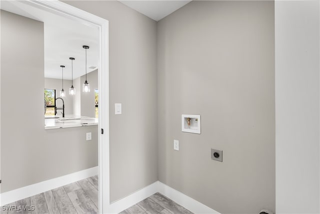 washroom with washer hookup, light wood-type flooring, and electric dryer hookup