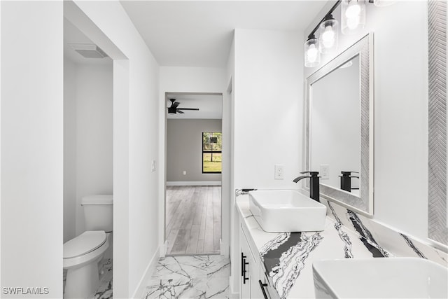 bathroom featuring vanity, toilet, ceiling fan, and hardwood / wood-style flooring