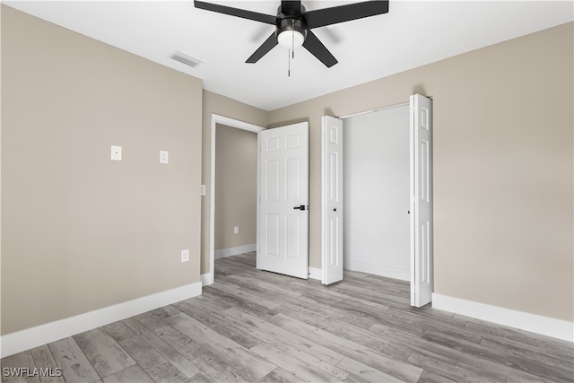 unfurnished bedroom with ceiling fan and light hardwood / wood-style flooring