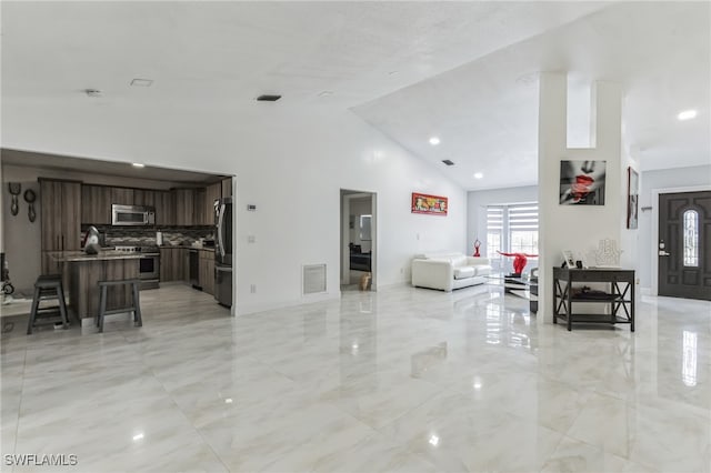 living room with high vaulted ceiling