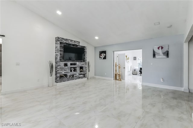 unfurnished living room featuring vaulted ceiling