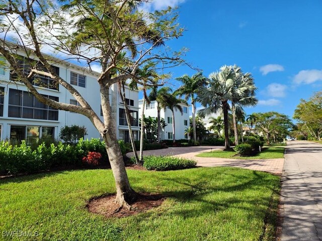 view of property's community with a lawn