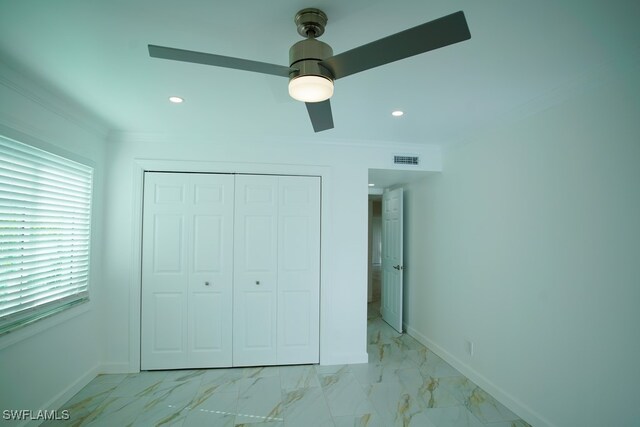 unfurnished bedroom with a closet, ceiling fan, and crown molding