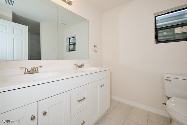 bathroom featuring vanity, tile patterned floors, and toilet