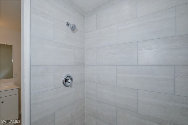 bathroom featuring vanity and a tile shower