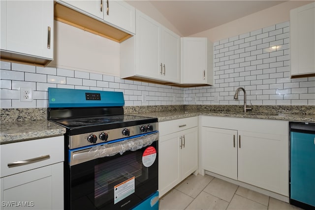 kitchen featuring backsplash, appliances with stainless steel finishes, light stone counters, and white cabinets